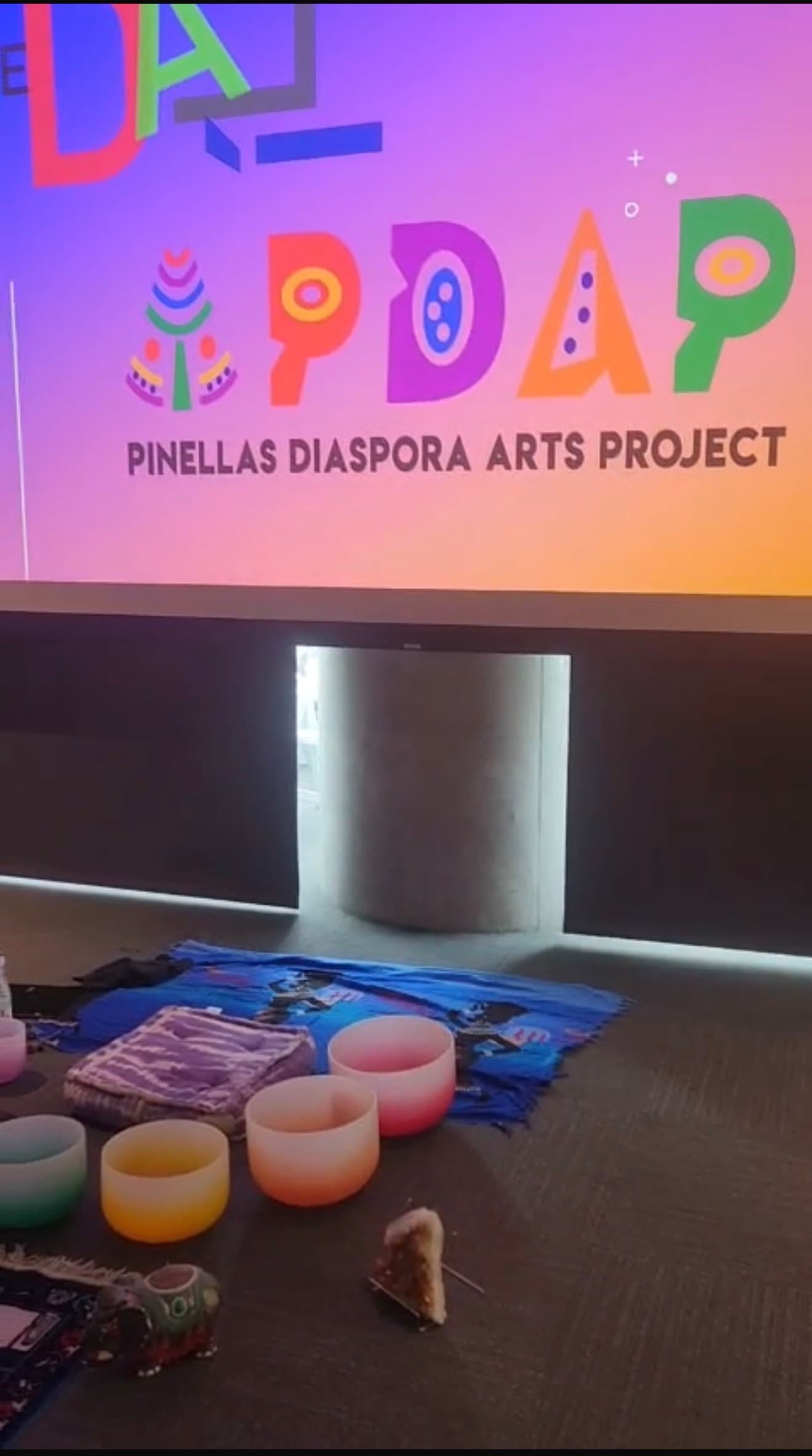 Sound bath setup in front of a Pinellas Diaspora Arts Project projection